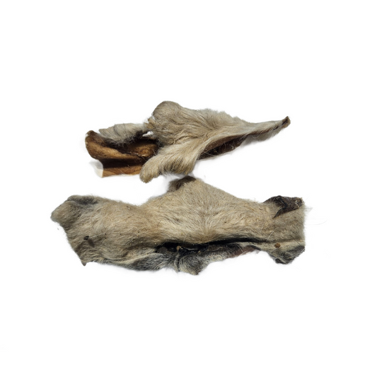 Two pieces of lamb skin with fur on a white background